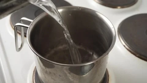 The cook puts the pan on an electric stove, close-up, cooking Stock Footage 240903953