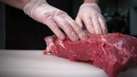The cook puts a piece of beef on the board and checks it Stock Footage 204718017