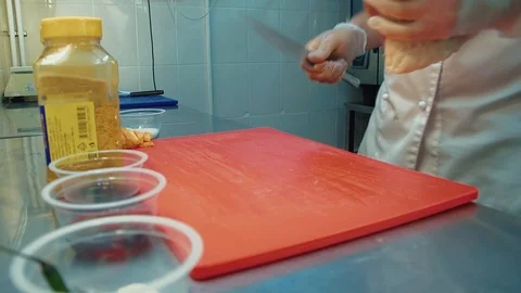 Cook puts a piece of meat on a cutting board Stock Footage 104936091