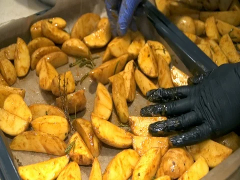 The cook puts the potatoes on a baking sheet Video stock 81310426