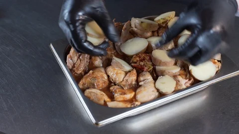 The cook puts the potatoes on a baking sheet Stock Footage 127565355