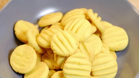 Cook puts prepared biscuits into the plate Stock Footage 83170004