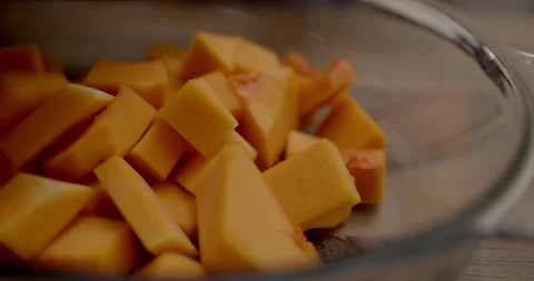 The cook puts the pumpkin in a glass dish for baking. Close-up. Stock Footage 201466529