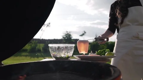 The cook puts raw calamari to the self cooked sauce before roasting on the open Stock Footage 77547862