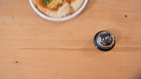 Cook puts ready cheese pizza on wooden table and rings bell Video stock 127214985