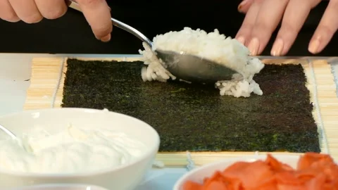 Cook puts rice on nori Stock Footage 88498897
