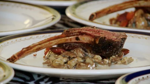Cook Puts Sauce on Deer Meat Dish Stock Footage 107565099