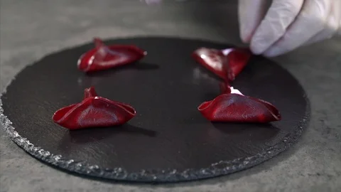 The cook puts the serving board on the table. Beetroot appetizer Stock Footage 126536484