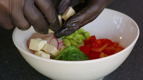 Cook puts soft cheese on a salad plate. Stock Footage 158775034