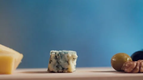 The cook puts some cheese with olives and nuts on the board Stock-Footage 131420719