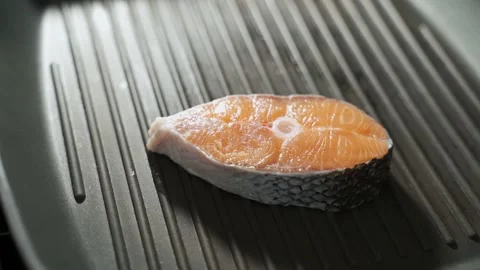 Cook puts steak raw salmon fillet on the grill grate 動画素材 149025842