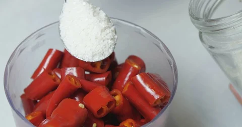 The Cook Puts Three Tablespoons Of  Sea Salt In A Blender With Chili Peppers Vídeos de archivo 128096308