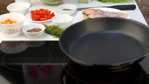 Cook puts two pieces of chicken fillet with a stuffing into a frying pan Video stock 84354886
