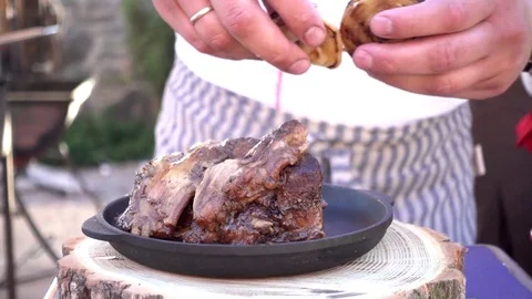 Cook puts under fried onions on a piece of meat on the grill Stock Footage 76016349