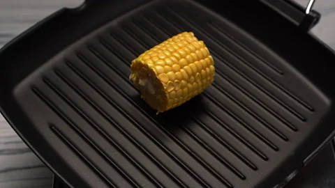 A cook puts vegetables on the grill pan. Bbq at home 4 k video. Cooking dinner Stock Footage 164234846