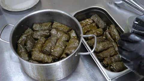 The cook putting the dolma into a metal container in the restaurant kitchen. Stock Footage 319431172