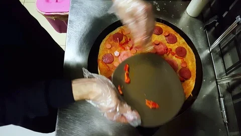 Cook putting some capia pepper left on a plate on crepe on a black cooker Stock Footage 103882286