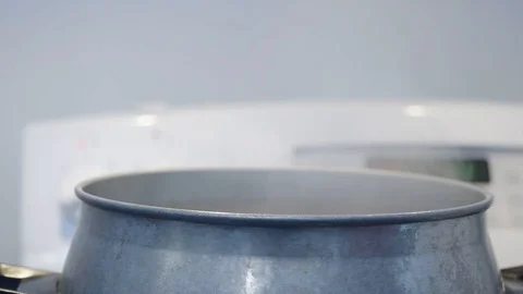 A cook is putting on the upper part of the couscous pot Stock Footage 129993454