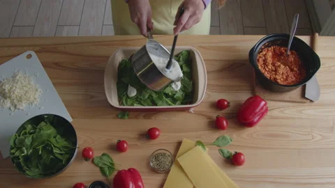 Cook Is Putting White Sauce Layer On Meal Video stock 170514528