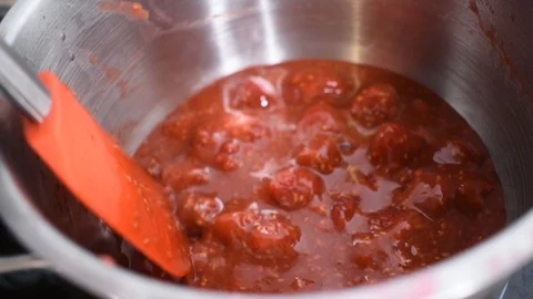 Cook raspberry jam compote for cake. Stir jam in a pan with silicone spatula Stock Footage 124609910