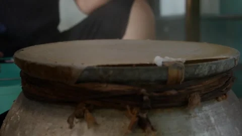 Cook removes a thin rice sheet from a steaming surface while lifting it Stock Footage 332300820