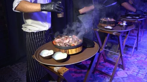 The cook in the restaurant serves a meat dish Stock Footage 117729496