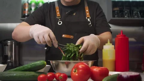 Cook in restaurant's kitchen makes salad with fresh herbs and honey mustard Stock Footage 291723723