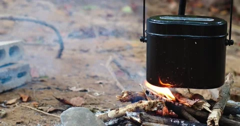 Cook rice in The small pots on fire bonfire at camping place , Cooking food  Stock Footage 142834369