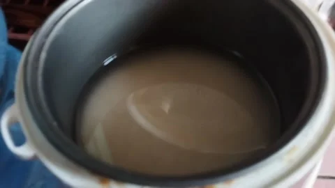 Cook rice using a rice cooker Stock Footage 212499115