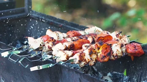 Cook roasts juicy kebab barbecue skewers of chicken and turkey with tomatoes Stock Footage 65821553