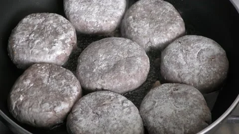 Cook roasts meat cutlets in a pan Stock Footage 137857784