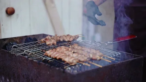 The cook roasts meat on the grill, makes a barbecue. Stock Footage 220800354