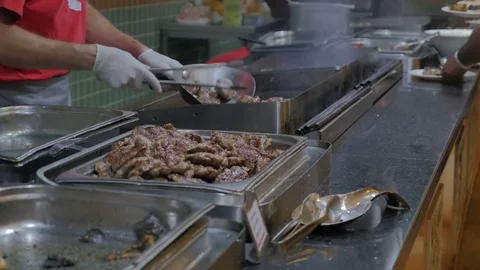 The cook roasts meat in the kitchen of the restaurant in the hotel Stock Footage 80633108
