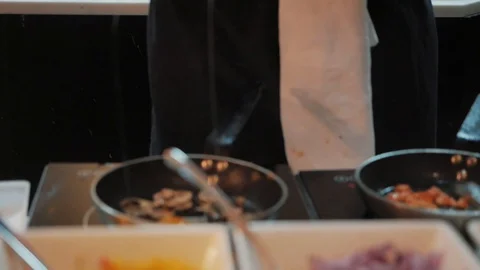 The cook roasts the scrambled eggs in a frying pan Stock Footage 124023876