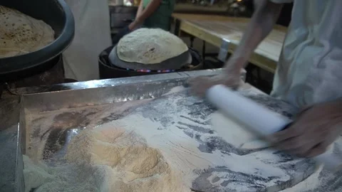 Cook Rolling Out Dough Chapati on Flour Dusted Wooden Table Surface Video stock 340480579