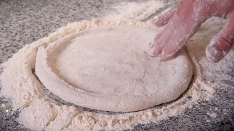 Cook rolls dough pointwise with fingers forming pizza shape Video stock 133077348