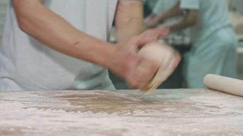 The cook rolls out the dough. Stock Footage 92579671