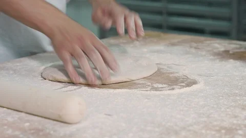The cook rolls out the dough Stock Footage 92579776
