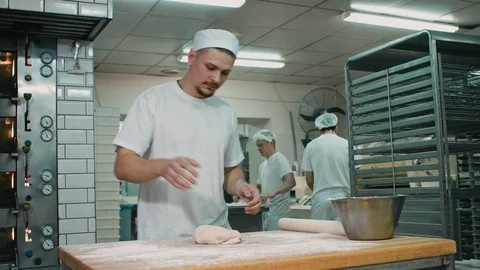 The cook rolls out the dough. Stock Footage 92580075