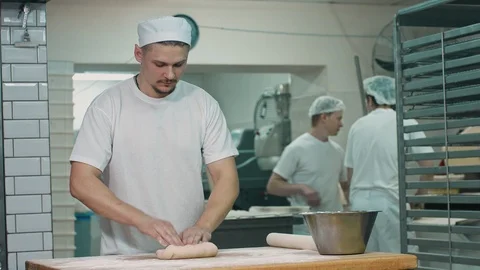 The cook rolls out the dough. Stock Footage 92580219