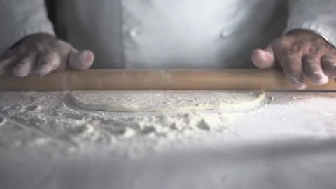 The cook rolls out the dough with a rolling pin. close-up. Stock Footage 152467951