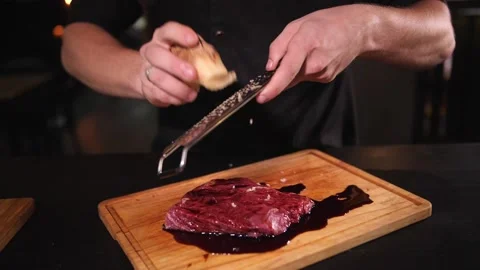 Cook rubs ginger on a beef steak grater Stock Footage 158996434