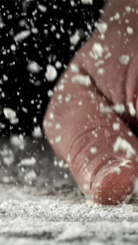 The cook runs his hand over the table with flour. Filmed on a high-speed camera Stock Footage 335360195