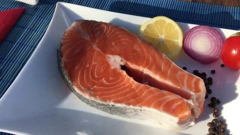 Cook Salmon Steaks  In the Background are Vegetables Stock Footage 70969765