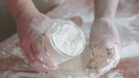 A cook scoops flour into a measuring cup. Stock-Footage 297947385