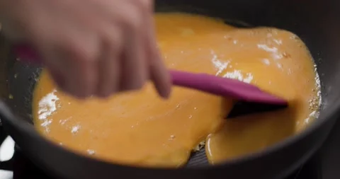 Cook the scrambled eggs on pan Stock Footage 132700013