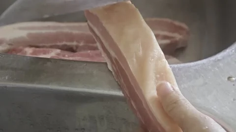 Cook Scraping and Cleaning Raw Pork Belly Skin in Kitchen Sink Video stock 337622613
