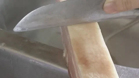 Cook Scraping Raw Pork Belly Rind with Knife over Kitchen Sink Video stock 337624146