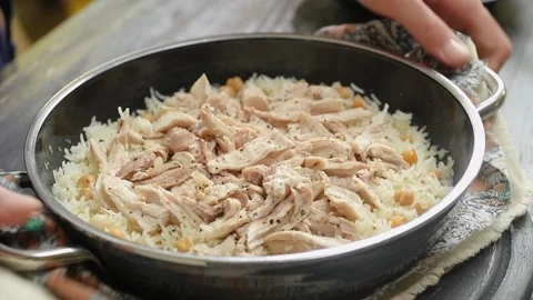 The cook serves chicken with rice on the table. Stock Footage 240376696