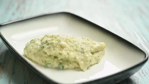 The cook serves courgette and white bean dip. Stock Footage 247895708